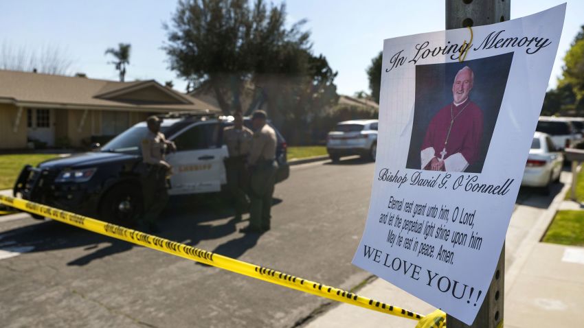 Los Angeles County Sheriff deputies guard the entrance to the street of Bishop David O'Connell's home in Hacienda Heights, Calif., Sunday, Feb. 19, 2023. According to the Los Angeles County Sheriff's Department, detectives are investigating the death of O'Connell, who was shot and killed Saturday just blocks from a church, as a homicide. (AP Photo/Damian Dovarganes)