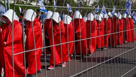 Demonstrators dressed as handmaids from the dystopian book 