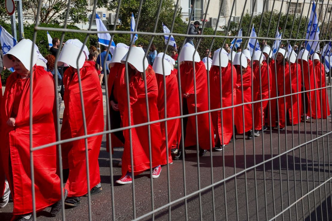 Demonstrators dressed as handmaids from the dystopian book "The Handmaid's Tale" protest in Tel Aviv on Monday. 