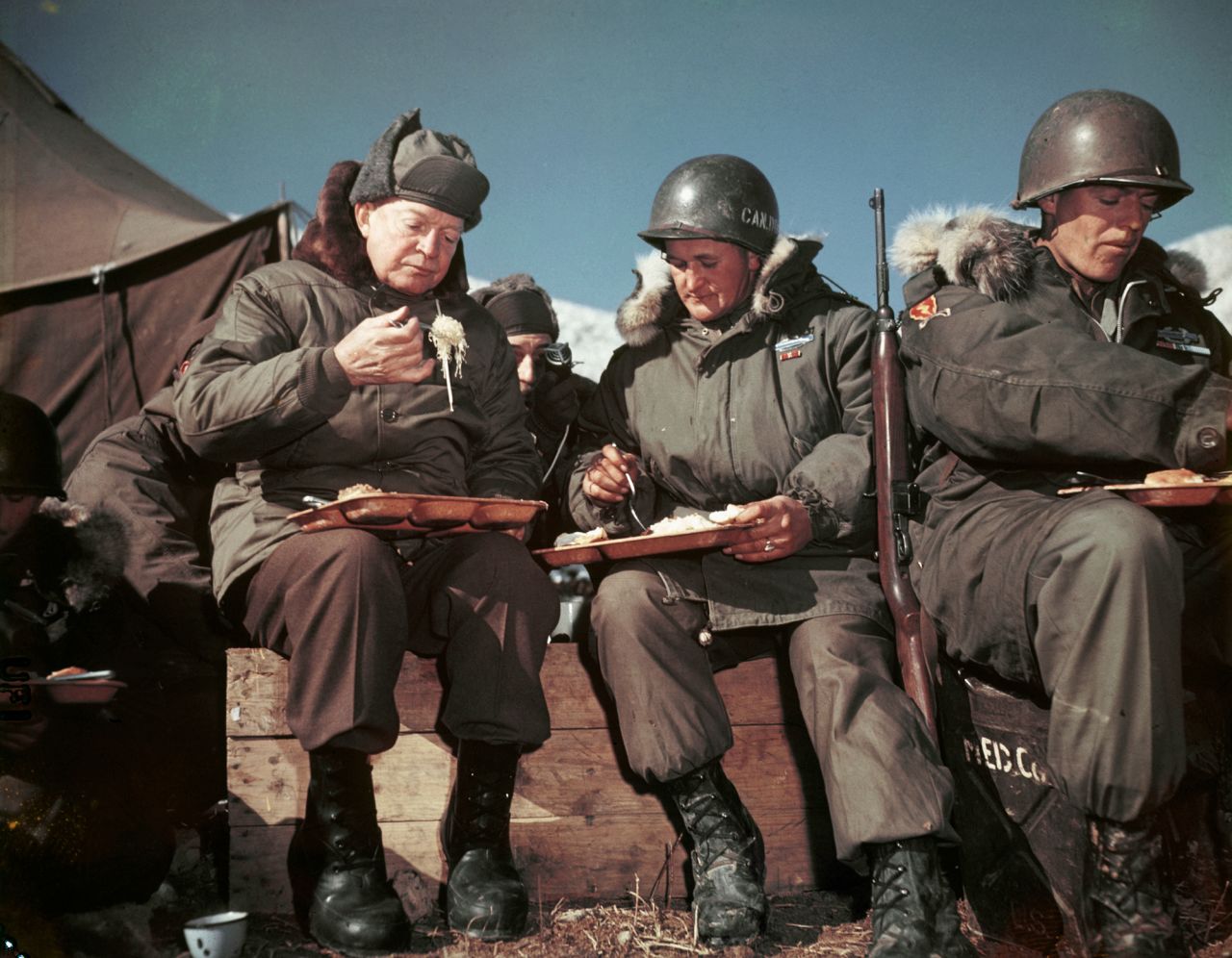 Eisenhower, as president-elect, eats with American soldiers on the front lines of the Korean War in December 1952.