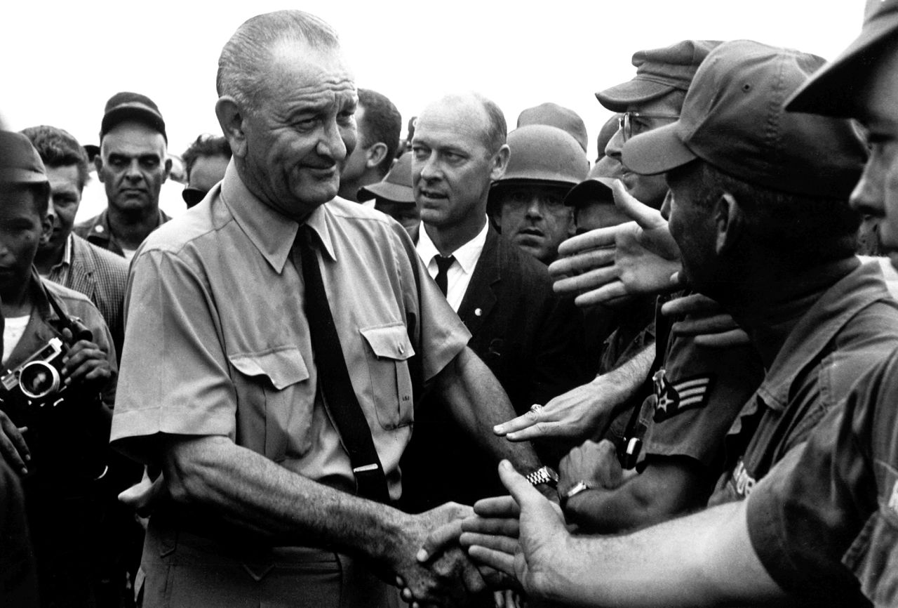 President Lyndon B. Johnson shakes hands with American troops while visiting Vietnam in 1966.