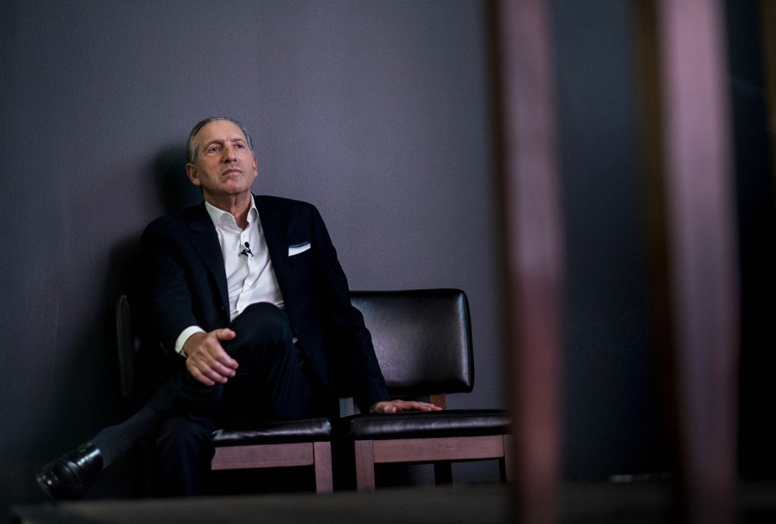 Howard Schultz sits off stage to listen incoming Starbucks CEO Laxman Narasimhan at the company's investor day in September in Seattle, Washington.