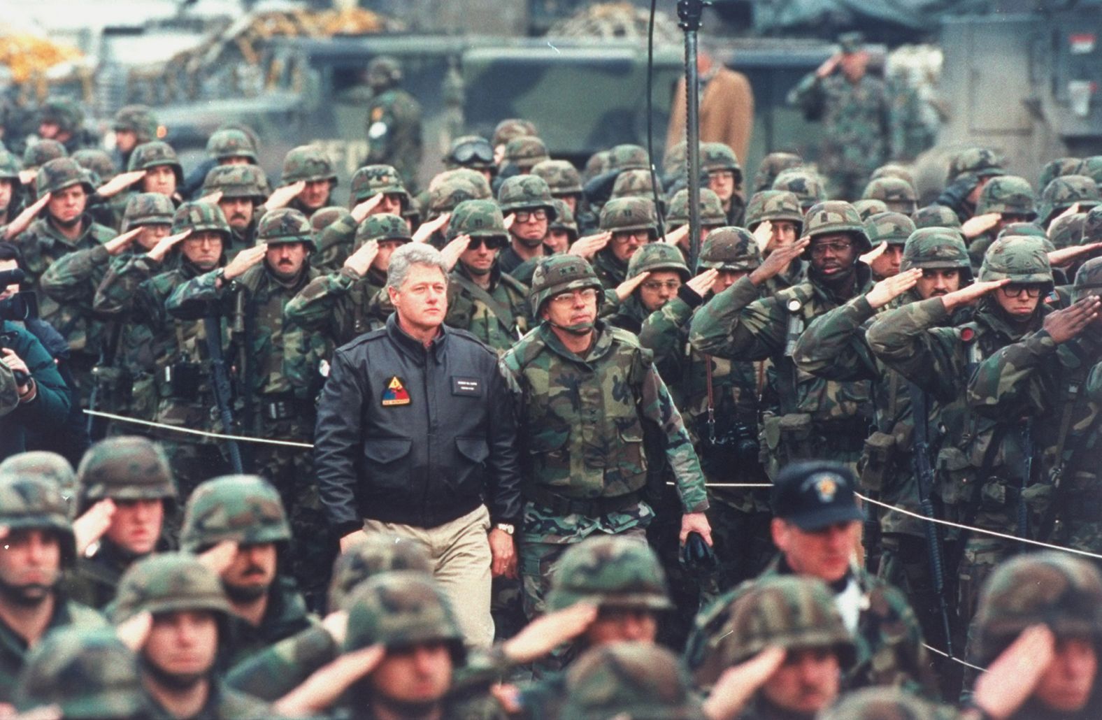 In January 1996, US troops salute President Bill Clinton in Bosnia and Herzegovina. US forces were there as part of peacekeeping efforts in the former Yugoslavia.