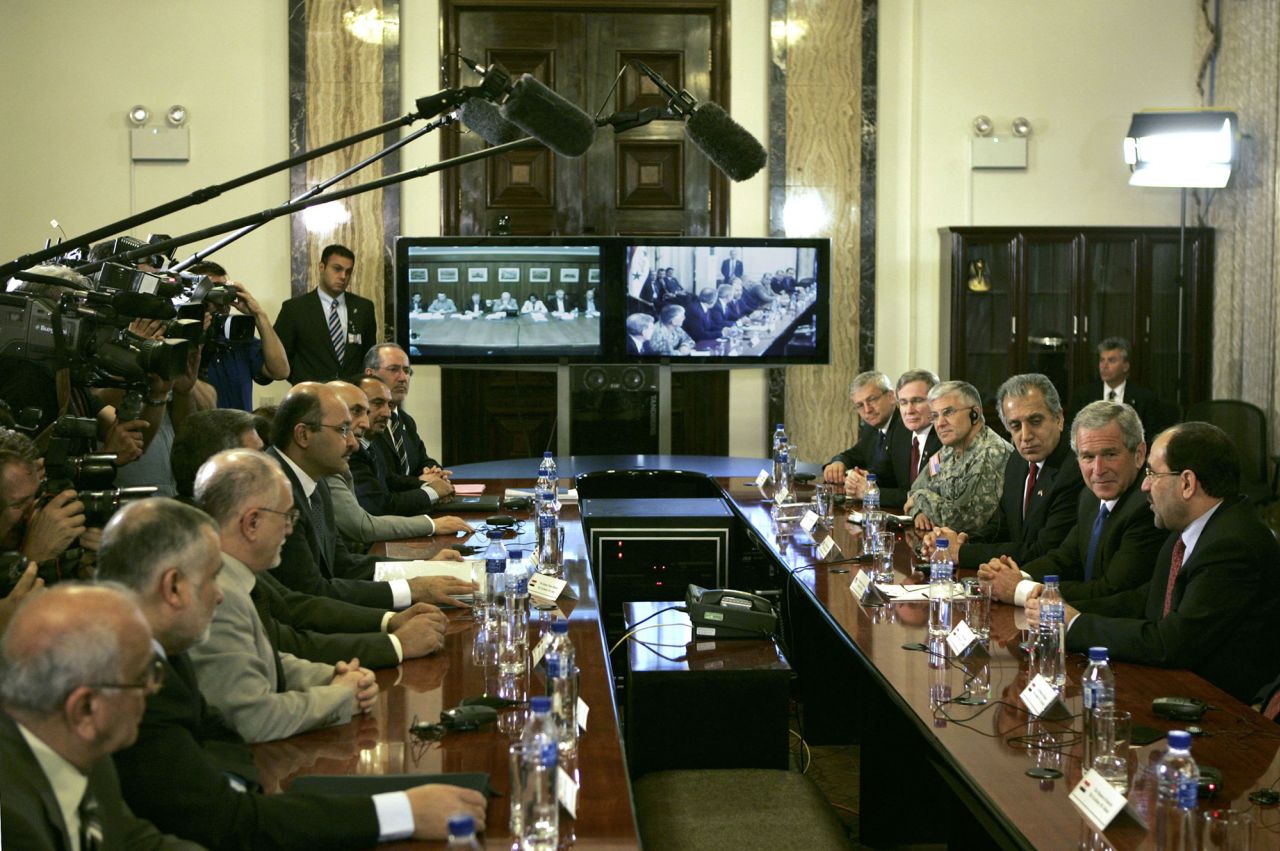 Bush, second from right, attends a teleconference with members of the US and Iraqi cabinets while visiting Baghdad in June 2006. Bush had made a surprise visit to meet with Iraqi Prime Minister Nouri al-Maliki.