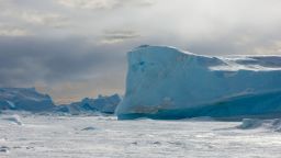 Blue iceberg stuck in the sea ice of the Weddell Sea, Antarctica. 