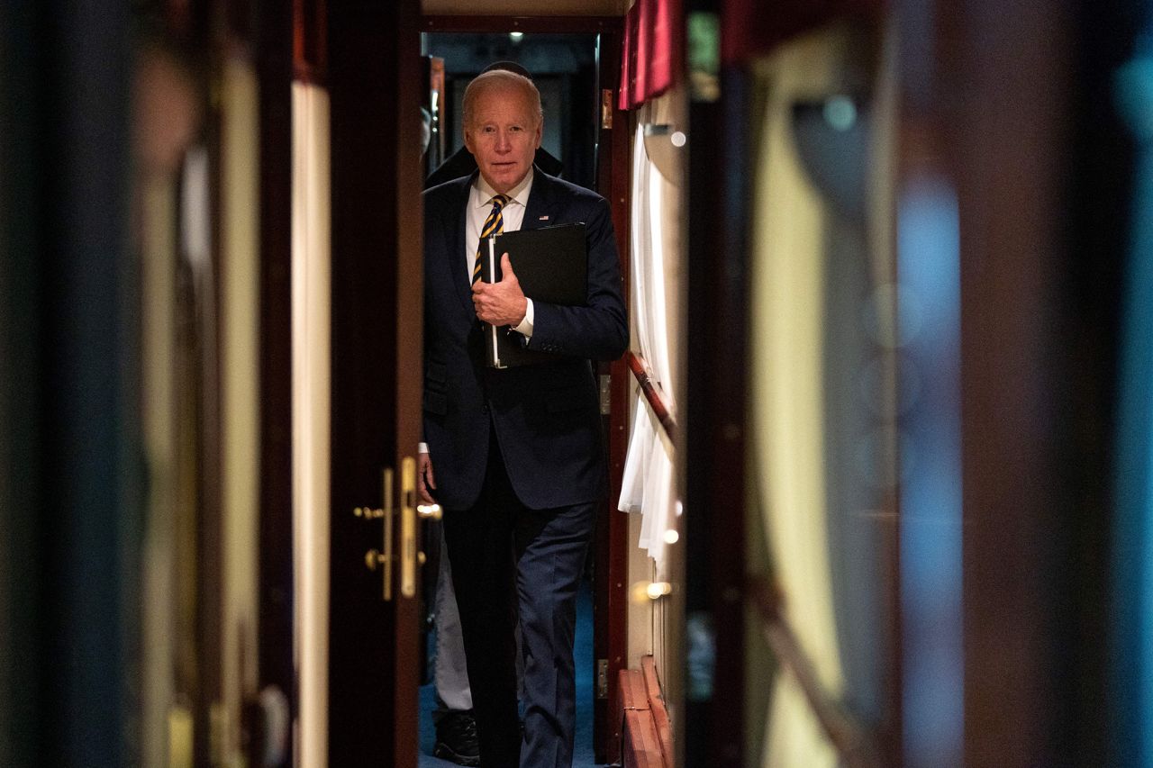 Biden walks down a train corridor to his cabin after visiting with Zelensky. He took a <a href="https://www.cnn.com/2023/02/20/politics/president-biden-kyiv-trip/index.html" target="_blank">nearly 10-hour train ride</a> from Poland into Kyiv.