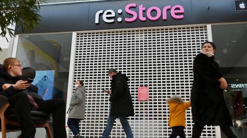 People walking past a closed Apple reseller at a mall in Omsk, Russia in March 2022. 