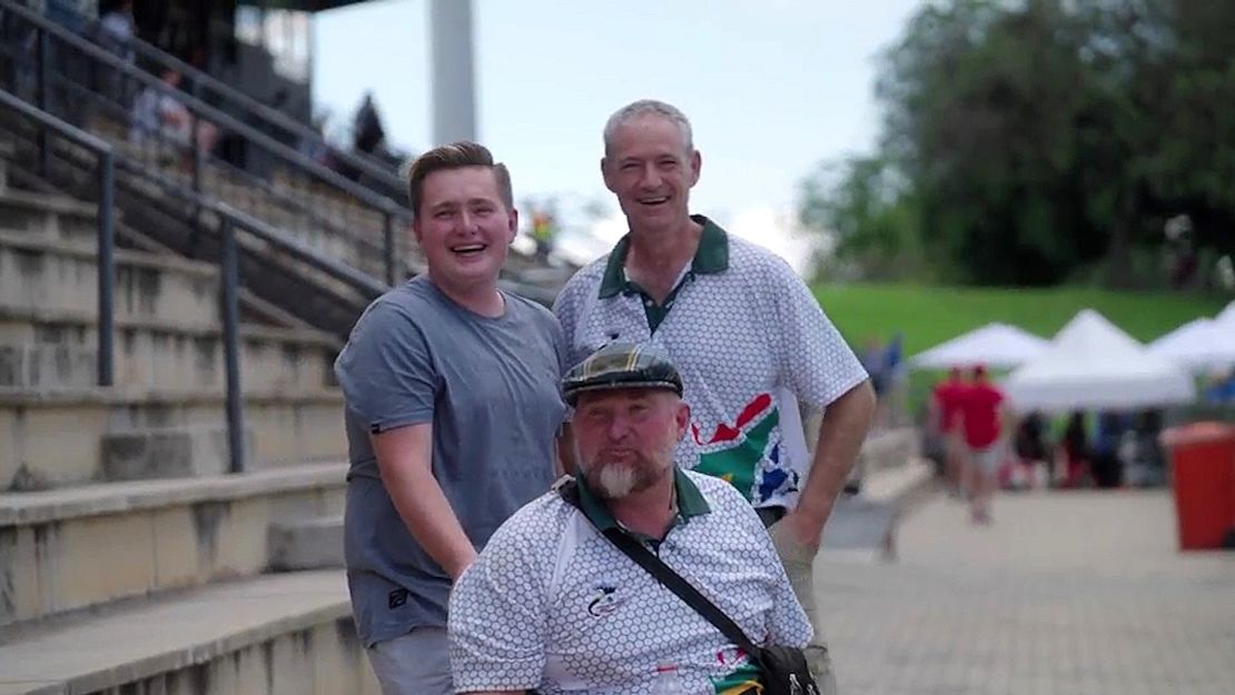 Shaun Anderson (middle) cheers on archers at the African Archery Championships with his son (left) and friend, Philip Coates-Palgrave (right).