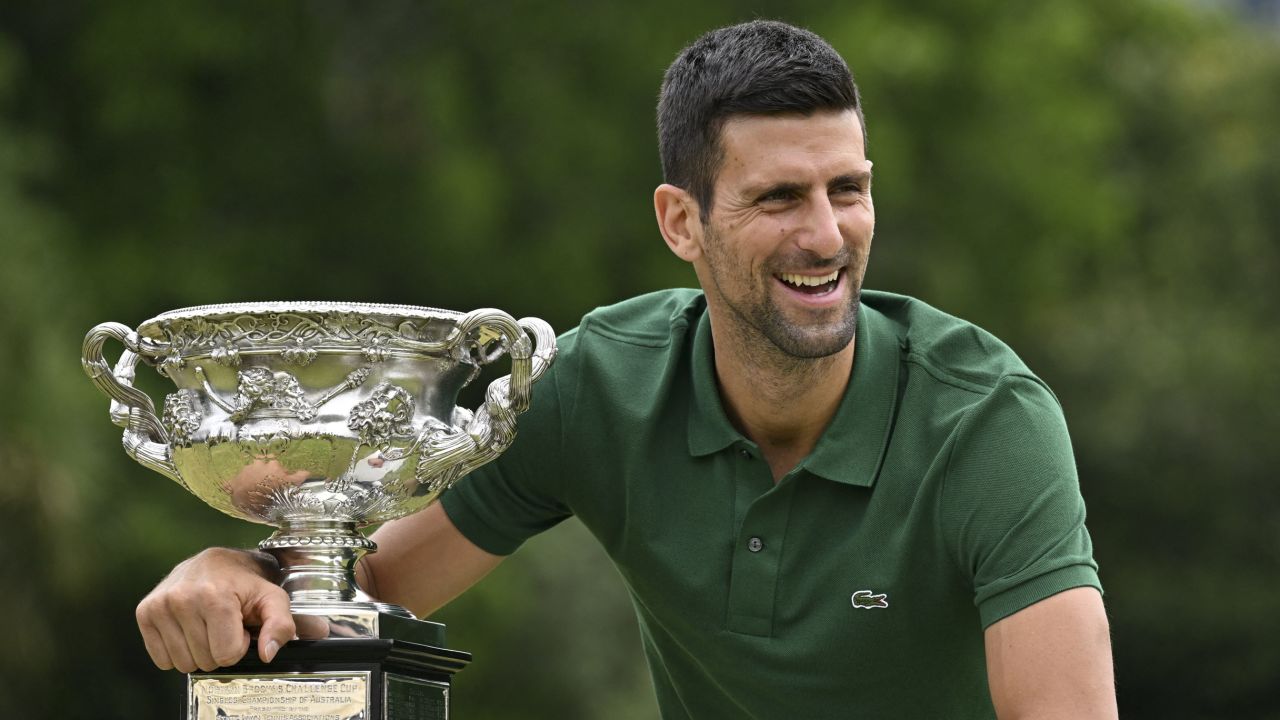 Novak Djokovic holds the Norman Brookes Challenge Cup trophy following his Australian Open victory.