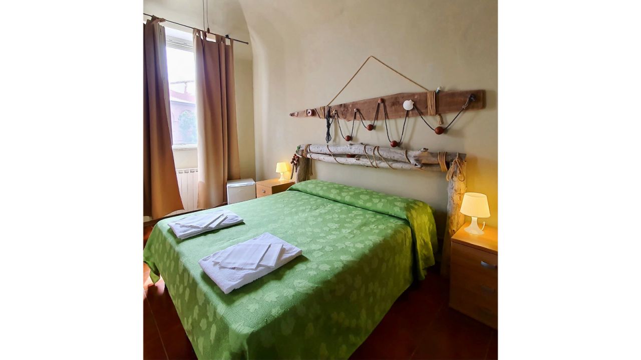 <strong>Pastel-colored rooms:</strong> Open year-round, Hotel Milena has 11 rooms with wooden furniture and a sea view.