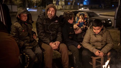 People in the southern Turkish province of Kahramanmaras, pictured on Monday, try to stay warm by a fire following the powerful tremors.
