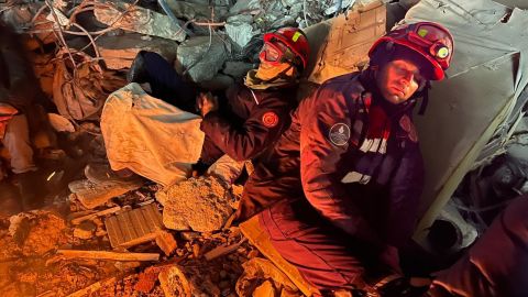 Rescue workers sleep on rubble in Antakya, Turkey, where their colleagues are trying to rescue three men trapped inside a collapsed building.
