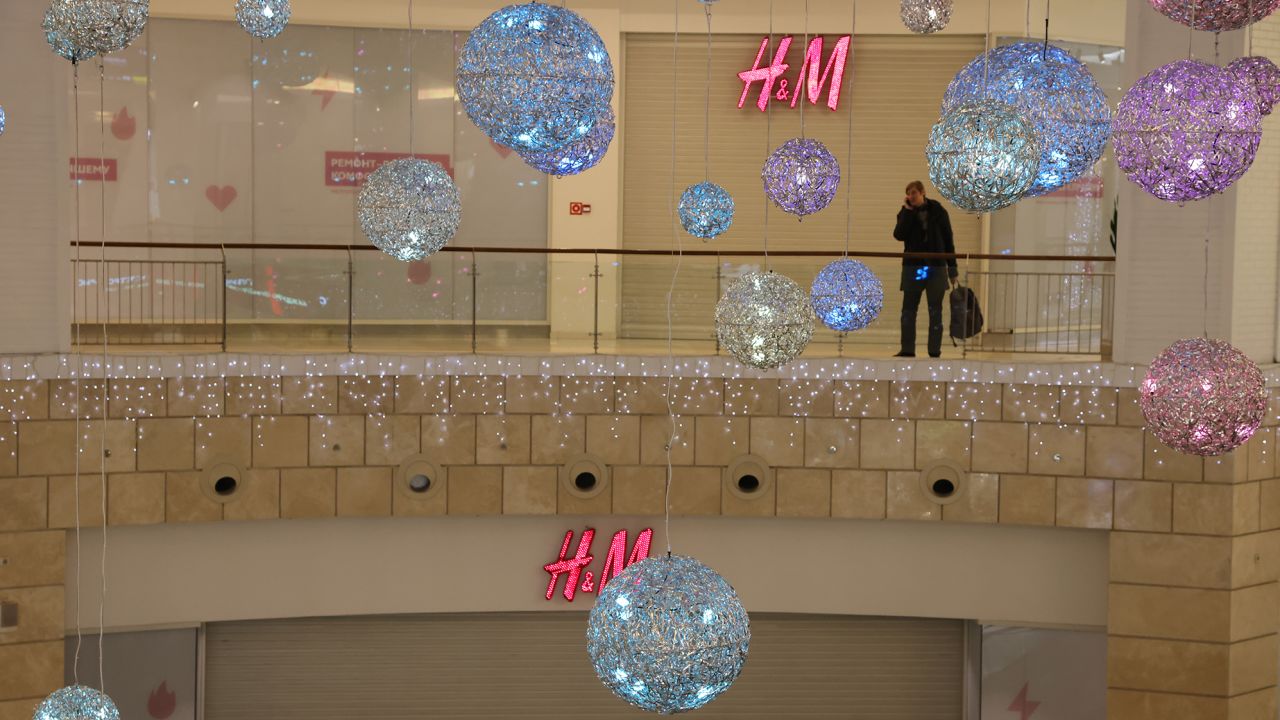 A man talks on his phone near a closed H&M store on December 15, 2022 in Moscow, Russia. 