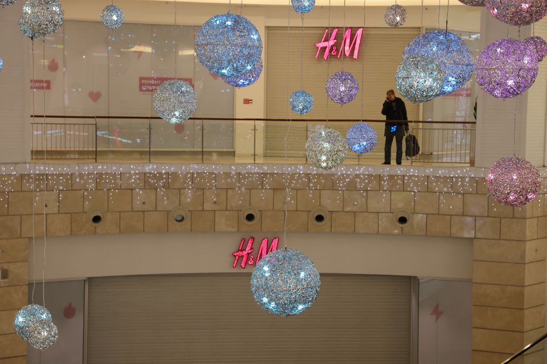 A man talks on his phone near a closed H&M store on December 15, 2022 in Moscow, Russia. 