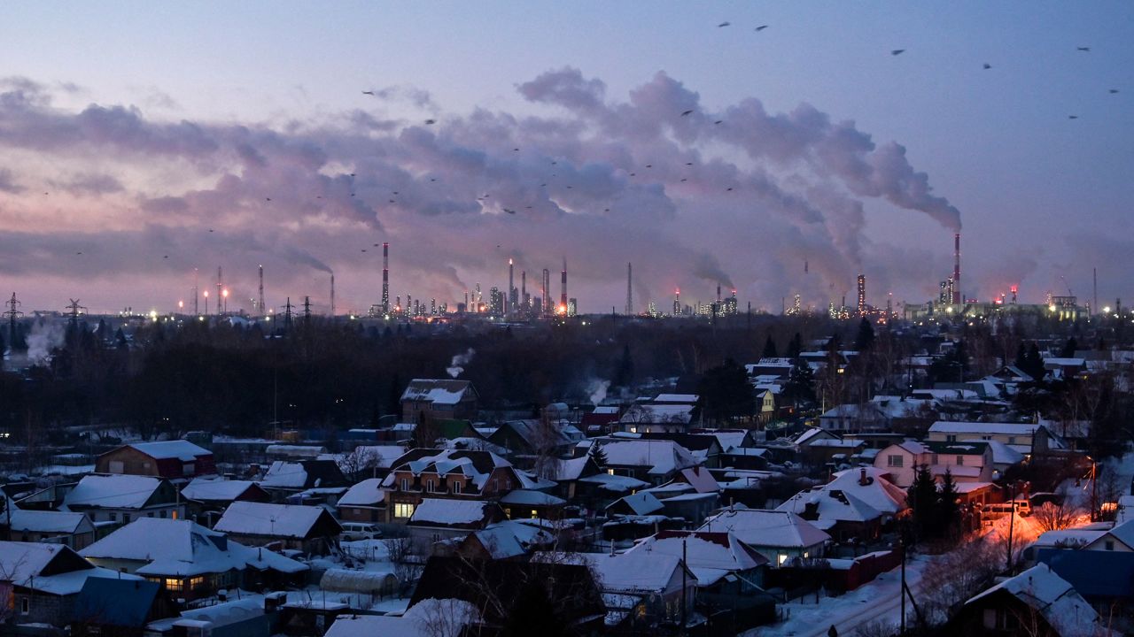 Birds fly above buildings at an oil refinery in the Siberian city of Omsk, Russia, on February 8, 2023. 