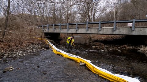 A member of Ohio EPA Emergency Response looks for fish at Leslie Run creek and checks for chemicals in East Palestine on Monday.