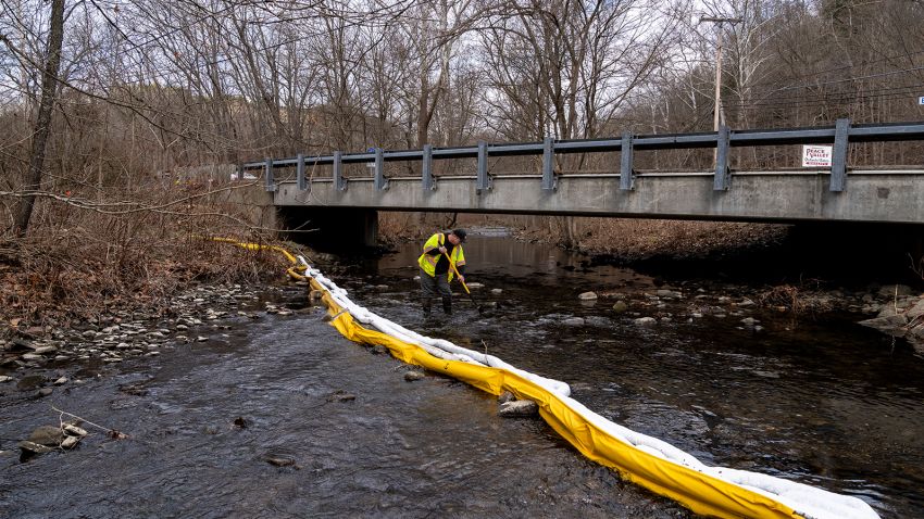 A member of Ohio EPA Emergency Response, looks for signs of fish and also agitates the water in Leslie Run creek to check for chemicals that have settled at the bottom following the train derailment prompting health concerns on February 20, 2023 in East Palestine, Ohio.