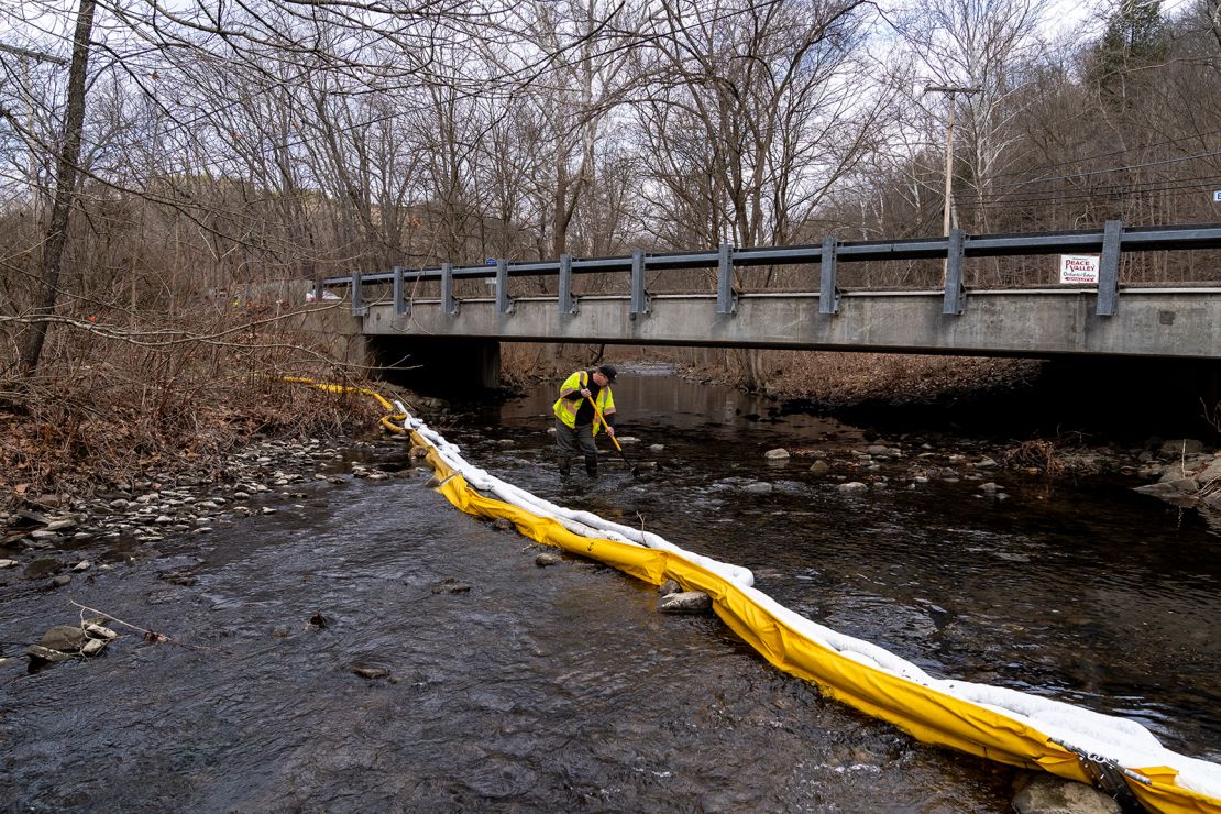 A member of Ohio EPA Emergency Response looks for fish at Leslie Run creek and checks for chemicals in East Palestine on Monday.