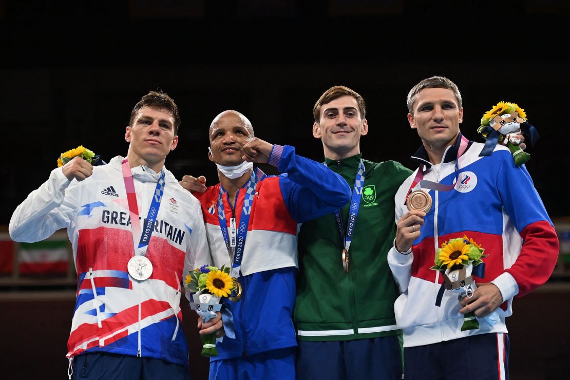 (Left to right) Silver medalist Pat McCormack, gold medalist Cuba's Roniel Iglesias and bronze medalists Russian Olympic Committee's Andrei Zamkovoi and Ireland's Aidan Walsh celebrate on the podium after the men's welterweight boxing final at the 2020 Olympics. 