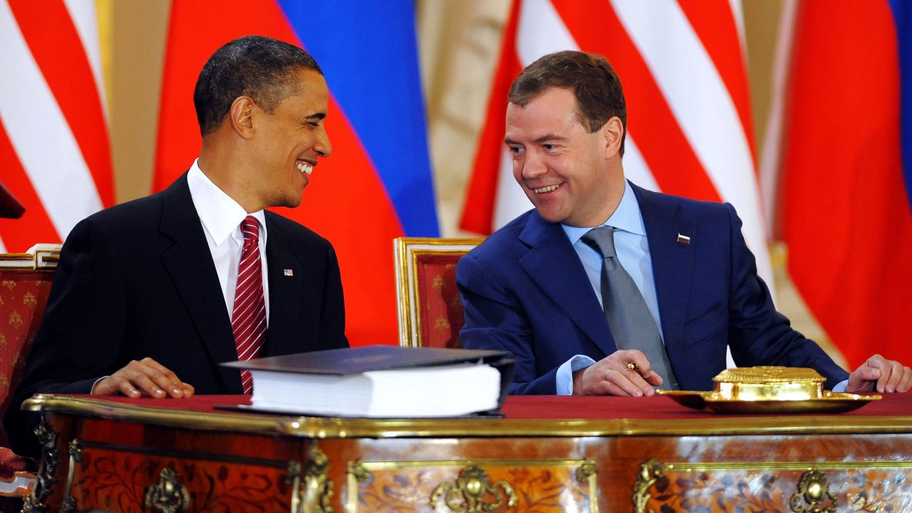 President Barack Obama laughs with his Russian counterpart Dmitry Medvedev as they sign the New START treaty in Prague on April 8, 2010.