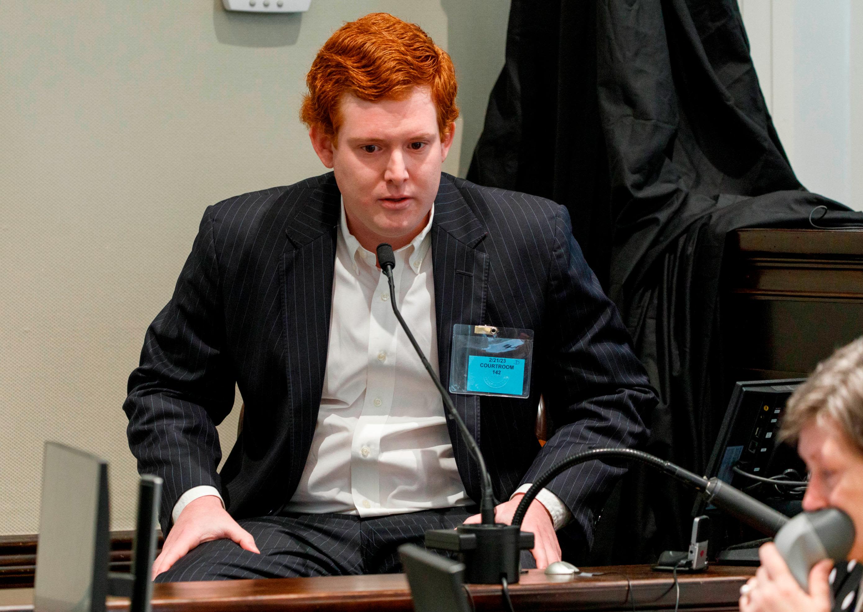 Buster Murdaugh, right, the son of Alex Murdaugh, listens to a