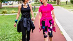 Happy mother and daughter enjoying in walk outdoors in park.