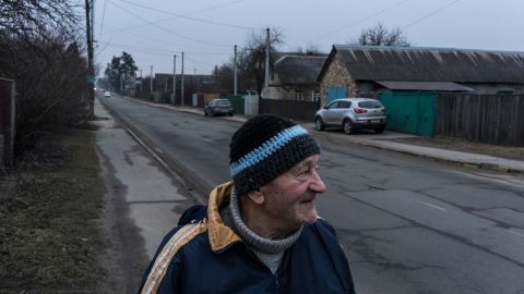 Ivan Fedorov stands on his street in Bucha, where he and his wife lived through the Russian occupation last year.