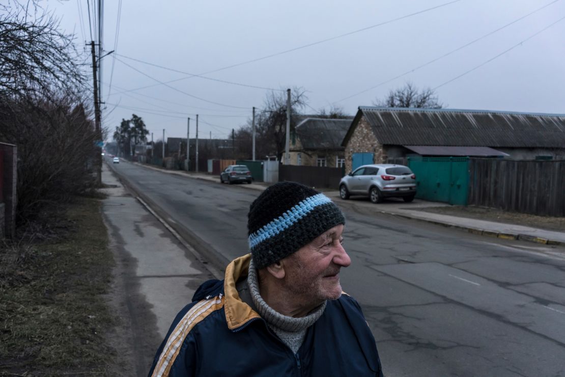 Ivan Fedorov stands on his street in Bucha, where he and his wife lived through the Russian occupation last year.