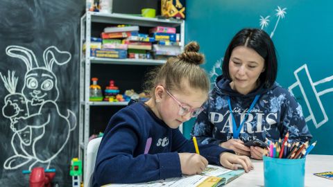 A year after the Russians' brutal occupation, Bucha is rebuilding. But the survivors remain broken 10 Nastia Mykolaietz watches her 9-year-old daughter, Sonya, draw at the UNICEF assistance center where she works.