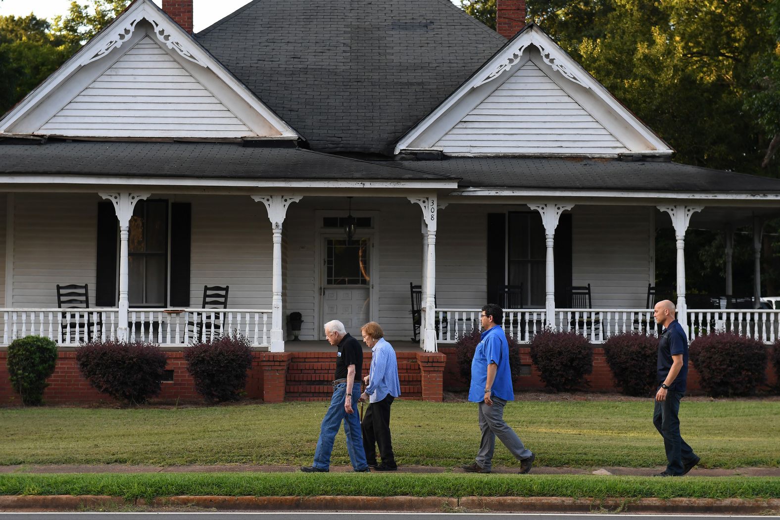 Carter walks with his wife, Rosalynn, and Secret Service members after having dinner at a friend's home in Plains, Georgia, in August 2018.