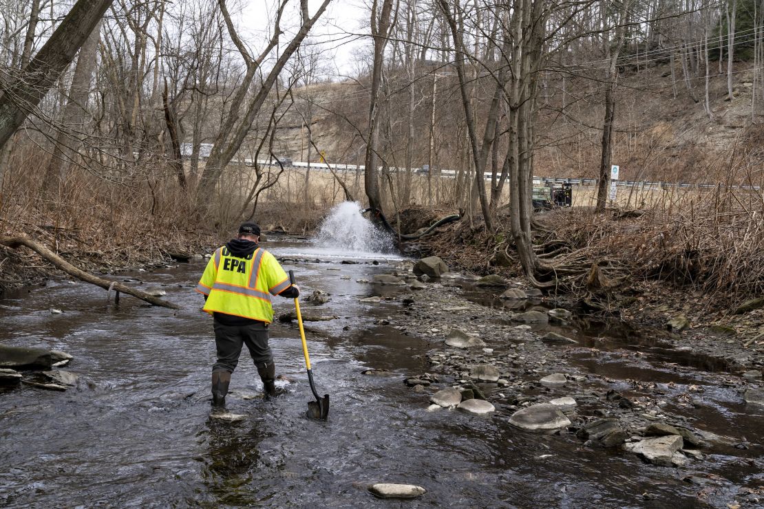 Ron Fodo with Ohio EPA Emergency Response checks for chemicals that might have settled at the bottom of Leslie Run Creek on Monday.