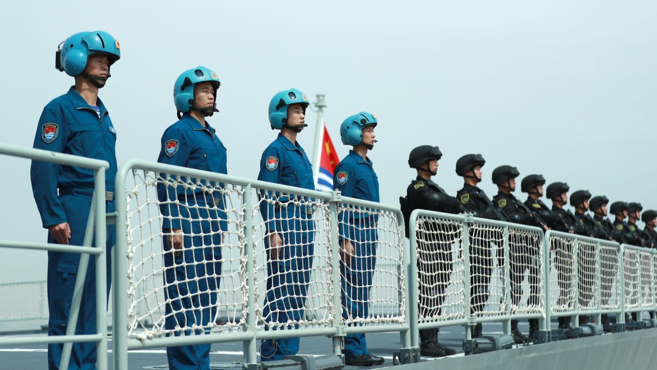 Members of the Chinese navy stand on the deck of a navy ship at a military port on May 18, 2022, in Zhoushan, China.