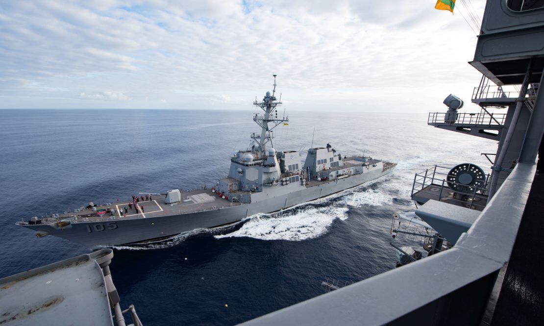 The US Navy guided-missile destroyer USS Dewey refuels at sea with the Nimitz-class aircraft carrier USS Carl Vinson on October 11, 2018. 