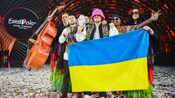 TOPSHOT - Members of the band "Kalush Orchestra" pose onstage with the winner's trophy and Ukraine's flags after winning on behalf of Ukraine the Eurovision Song contest 2022 on May 14, 2022 at the Pala Alpitour venue in Turin. (Photo by Marco BERTORELLO / AFP) (Photo by MARCO BERTORELLO/AFP via Getty Images)
