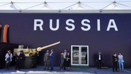 Russian salespeople stand by a tent for Russian weapons manufacturers at the International Defense Exhibition and Conference in Abu Dhabi, United Arab Emirates, on Monday. 