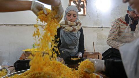 Volunteers prepare food to serve people affected by the earthquake in the government-held northern Syrian city of Aleppo on Tuesday.