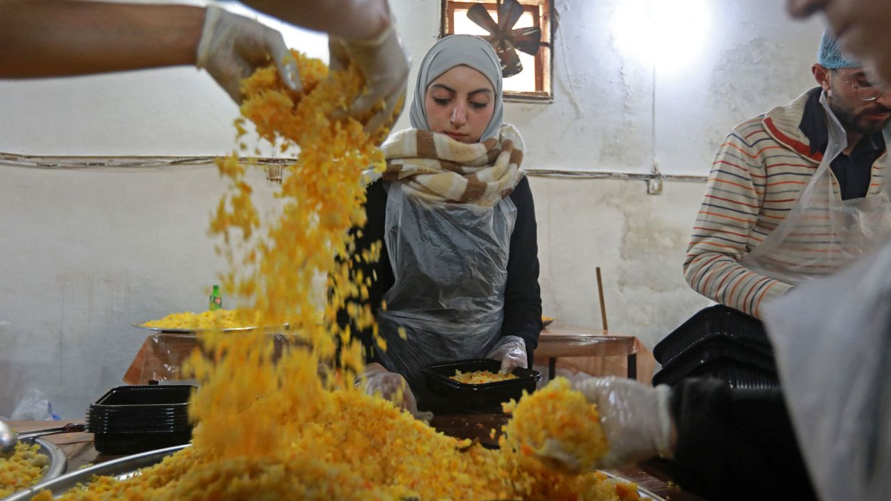 Volunteers prepare food to serve people affected by the earthquake in the government-held northern Syrian city of Aleppo on Tuesday. 