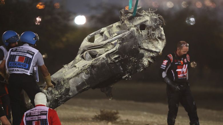 BAHRAIN, BAHRAIN - NOVEMBER 29: Track marshals clear the debris following the crash of Romain Grosjean of France and Haas F1 during the F1 Grand Prix of Bahrain at Bahrain International Circuit on November 29, 2020 in Bahrain, Bahrain. (Photo by Tolga Bozoglu - Pool/Getty Images)