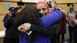 Thenmozhi Soundararajan, founder and executive director of Equality Labs, left, and Aneclah Afzali, dir. of the American Muslin empowerment Network, facing camera, hug after passage of an ordinance to add caste to Seattle's anti-discrimination laws in the Seattle City Council champers, Tuesday, Feb. 21, 2023, in Seattle. Council Member Kshama Sawant proposed the ordinance. (AP Photo/John Froschauer)