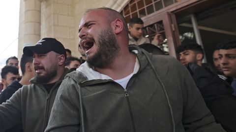 Relatives mourn the death of a Palestinian killed in an Israeli raid, outside a hospital in the West Bank city of Nablus on February 22, 2023. 