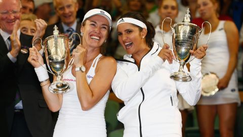 Mirza and Martina Hingis of Switzerland celebrate with the trophy after winning the final of the women's doubles at Wimbledon in 2015.