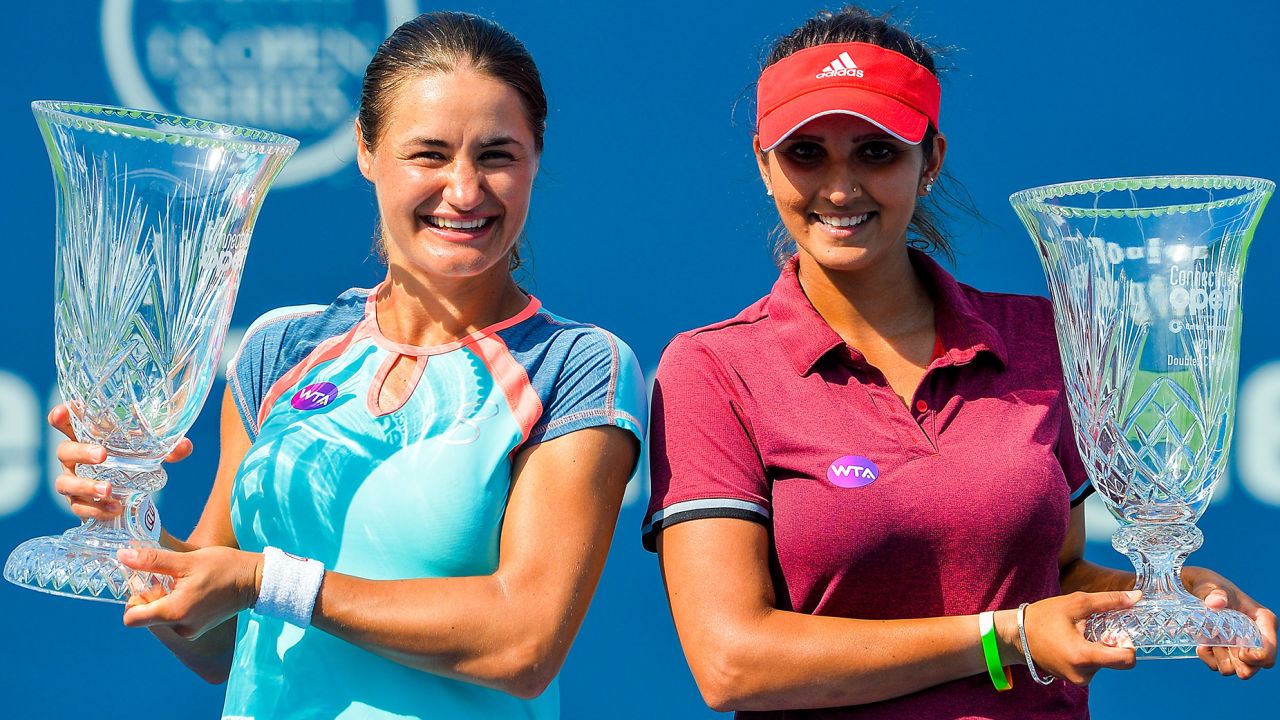 Mirza poses with Monica Niculescu of Romania after defeating Kateryna Bondarenko of the Ukraine and Chia-Jung Chuang of Taipei in the women's doubles final at the Connecticut Open in 2016.