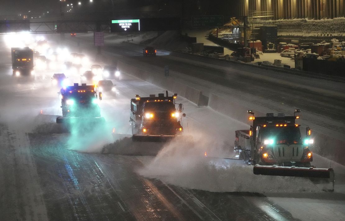 Plows move snow from I-35W southbound seen from the 42nd St. Bridge on February 22 in Minneapolis. 