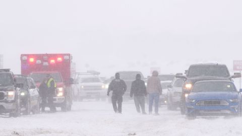 Police and emergency workers try to free vehicles from snow on Mountain View Parkway in Lehi, Utah, on February 22, 2023.