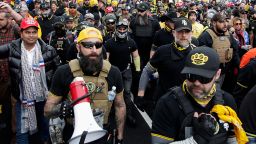 Far-right Proud Boys member Jeremy Joseph Bertino, second from left, joins other supporters of President Donald Trump who are wearing attire associated with the Proud Boys as they attend a rally at Freedom Plaza, Dec. 12, 2020, in Washington. 