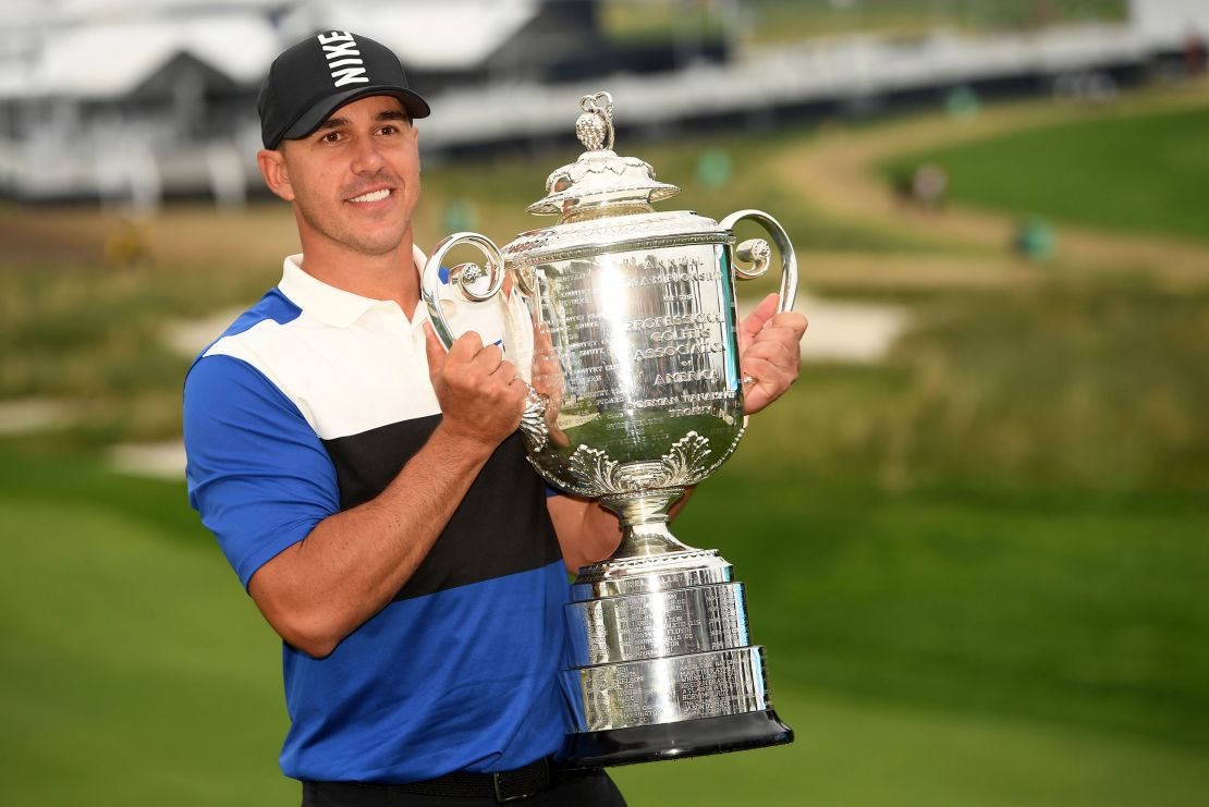 Koepka poses with the Wanamaker Trophy after capturing his second PGA Championship title in 2019.