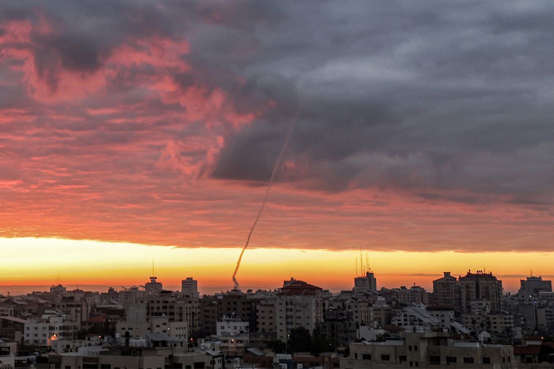 Smoke plumes rise as rockets are fired from Gaza City towards Israel at sunrise on Thursday.