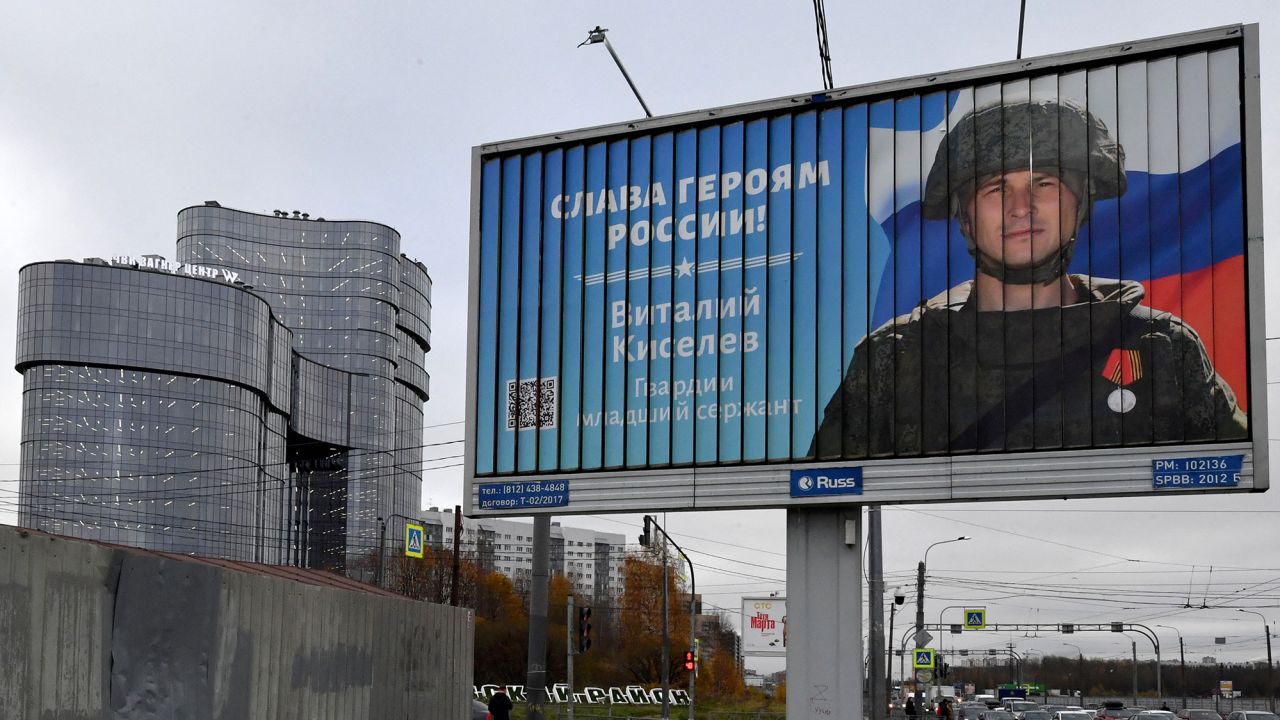 A poster displaying a Russian soldier with the slogan "Glory to the Heroes of Russia" decorates a street near the "PMC Wagner Centre" in Saint Petersburg, Russia, pictured in November 2022.