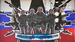 A mural depicting mercenaries of Russia's Wagner Group that reads: "Wagner Group - Russian knights" vandalized with paint on a wall in Belgrade, Serbia, Friday, Jan. 13, 2023.