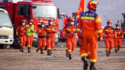 Rescue workers gather at the site.
